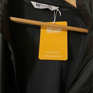 Brand new with tags men’s Helly Hansen rain jacket- black- regular fit - large.